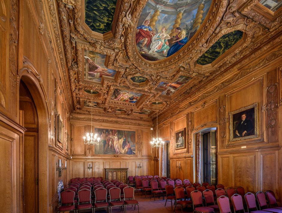 Image of beautiful theater with paintings on the wall and gold or bronze decor