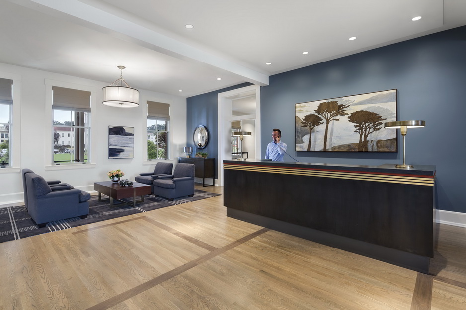 Image of interior front desk area, blue and white walls, in the Lodge at the Presidio