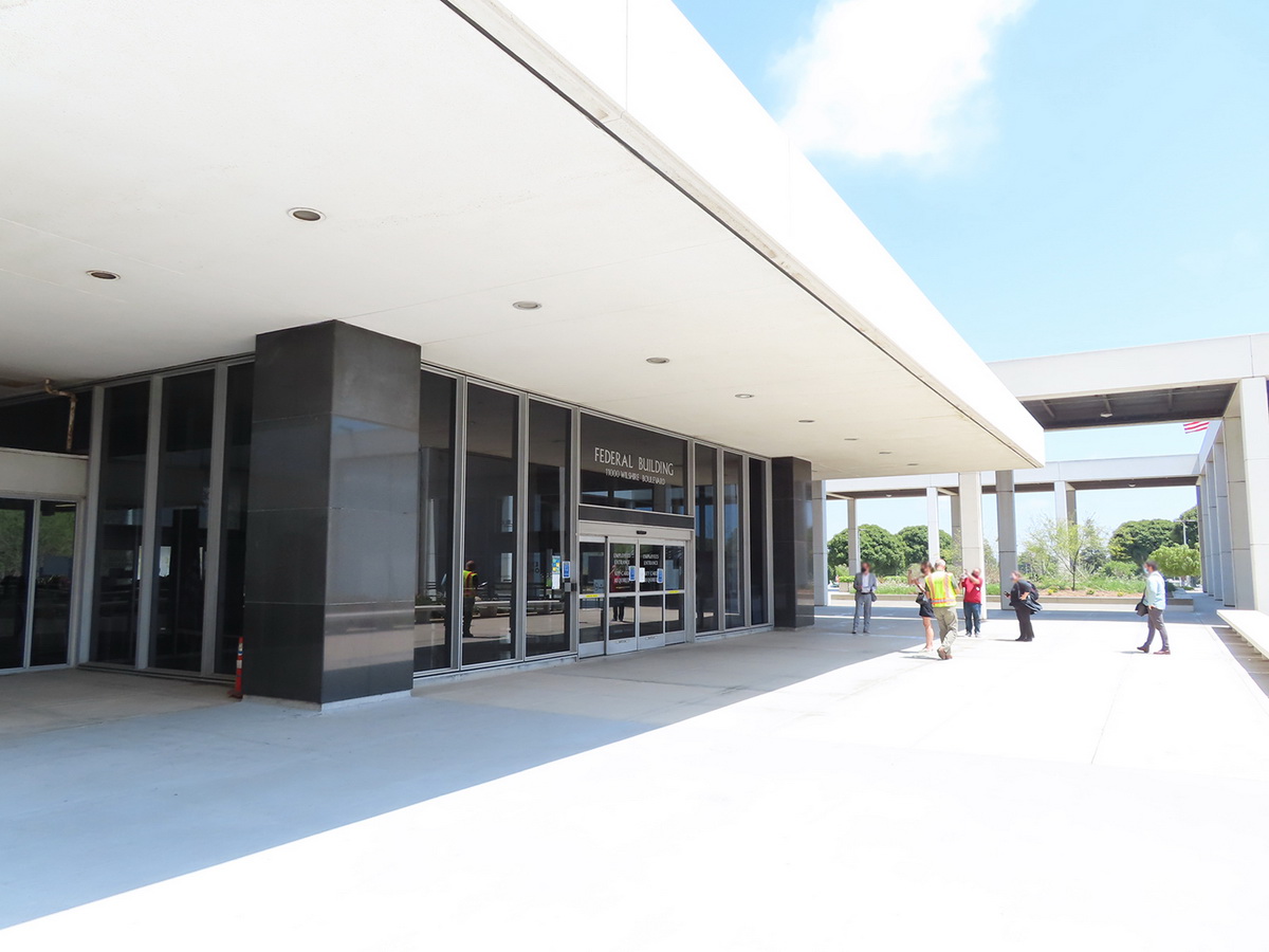 Blue skies, side entry to the 11000 Wilshire, black marble features with white roof